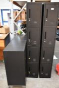 Four black lockable cabinets and an eight door lockable lockers