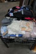 A large basket of assorted as new clothing.