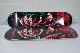 Two as new skateboard decks with a Damen Leone film Terrifier motif to deck