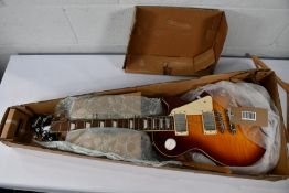 An Epiphone Les Paul Standard '60s Electric Guitar with a snapped off headstock.