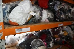 Eighteen bags of pre-owned clothing and related items.