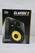 A boxed KRK Classic 5 Versatile Powered Nearfield Studio monitor.