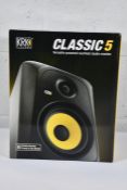 A boxed KRK Classic 5 Versatile Powered Nearfield Studio monitor.