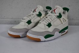 A pair of Nike SB Jordan 4 Retro 'Pine Green' in UK 8, No Box, Good Condition but red mark on one sh