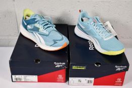 A pair of women's boxed Reebok Floatride Energy Symmetro running trainers in BLUPEA/STEBLU/FTWWHT (S