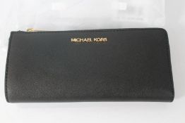 An as new Michael Kors Jet Set Travel Large Saffiano Leather Quarter-Zip Wallet.