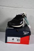 A pair of boxed Reebok Ridgerider 6.0 CBLACK/PUROAS/CHALK (Size 5.5).