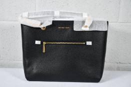 An as new Michael Kors Jet Set Large Pebbled Leather Tote Bag in Black.