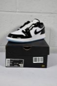 A pair of boxed as new Air Jordan 1 Low SE (GS) White/Black (UK 5.5) (Box slightly damaged).
