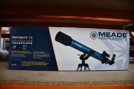 A boxed as new Meade Infinity 70 telescope.