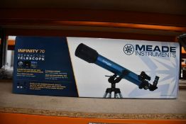 A boxed as new Meade Infinity 70 telescope.