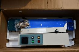 A boxed as new FR-900 Horizontal Automatic Band Sealer.