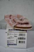 A pair of children's Arizona Shearling fur lined light Rose Birkenstocks (Size UK 13 (31)).