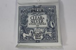 Twelve packs of Ernie Ball - Ernesto Palla Nylon Clear & Silver Classical Guitar Strings.