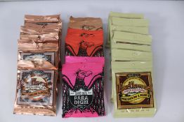 Twenty three sets of Ernie Ball Guitar Strings: Earthwood - 2146 (9), 2003 (8), Paradigm - 2015 (2),