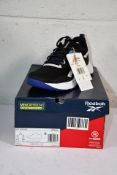 A pair of boxed Reebok Memerytech Comfortbed CBLACK/FTWWHT/BOLPRP NFX trainers (UK 4.5).