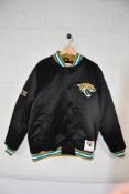 An as new Mitchell & Ness 2013 - 2023 satin jacket with Jacksonville Jaguars logo to back of jacket