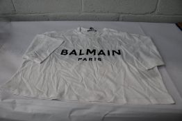 A Balmain white/black logo print cropped T-shirt (Size S).