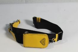 A Prada yellow/black shoulder strap for a hand bag with small pouch attached.