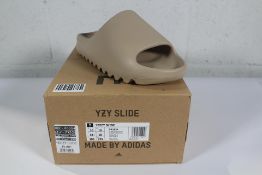 A pair of as new Adidas Yeezy Slides - Pure (UK 10).