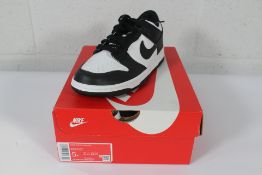 A pair of juniors boxed as new Nike Dunk Low (GS) - CW1590 100 - White/Black (UK 4.5).