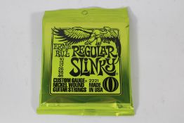 Twelve sets of Ernie Ball 2221 Regular Slinky Nickel Wound Electric Guitar Strings.