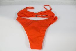 A Haight Monica bikini top in orange (Size M) and a Haight Leila bikini bottoms in orange (Size L).