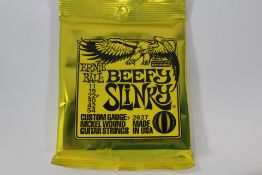 Ten packs of Ernie Ball 2627 Beefy Slinky Custom Gauge Electric Guitar Strings.