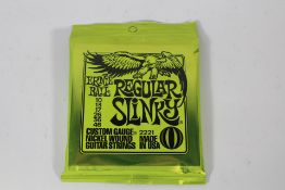 Twelve sets of Ernie Ball 2221 Regular Slinky Nickel Wound Electric Guitar Strings.
