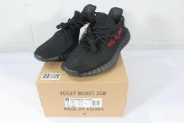 A pair of boxed as new Adidas Yeezy Boost 350 V2 - Black/Red (UK 10.5).