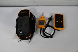 A Martindale electric proving unit and a Martindale VI - 15000 voltage indicator with a shoulder str