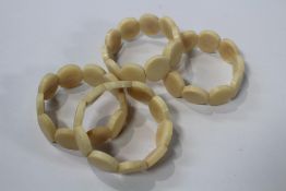 Approximately two hundred Tagua (Vegetable ivory) elasticated bracelets.