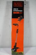 A Black + Decker 28cm Strimmer ST1820PC.