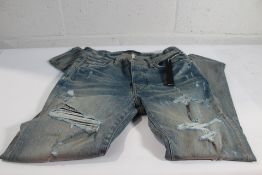 A pair of men's Amiri Thrasher Plus jeans in indigo clay (Size 31).