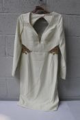 A Marchesa Notte Ivory long sleeved embellished cutout crepe dress (Size 6).