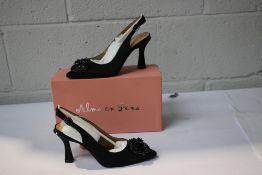 A pair of boxed Alna en Pena black satin slingback heels with wreath decoration to toe (Size 38).