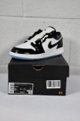 A pair of boxed as new Air Jordan 1 Low SE (GS) White/Black (UK 5.5) (Box slightly damaged).