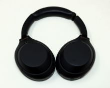 A pre-owned pair of Sony WH-1000XM4 Wireless Noise Cancelling Over-Ear Headphones in Black with Case