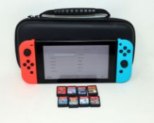 A pre-owned Nintendo Switch (HAC-001-01) Hand-Held Game Console with eight assorted game cards in
