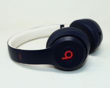 A pre-owned pair of Beats Solo3 Wireless Over-Ear Headphones in Navy with Storage Bag (Grade B/C).