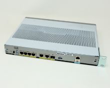 A pre-owned Cisco C1111-4P Integrated Services Router.