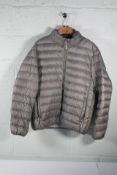 A pre-owned TUMI PAX Packable Travel Puffer Jacket in Grey, size large.
