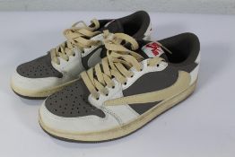 A pair of pre-owned Nike Air Jordan 1 Retro Low OG SP Travis Scott Reverse Mocha (UK 6).