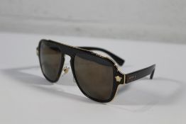 A pair of pre-owned Versace VE2199 Gold and Black Sunglasses. Part missing on left side of the sungl