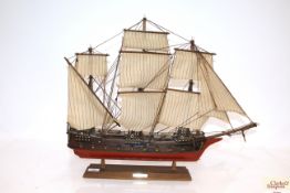 A model ship on display plinth with plaque 