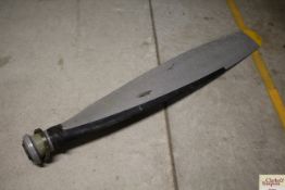 A metal propeller marked 