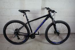 A Carrera Hellcat 29 mountain bike with aluminium