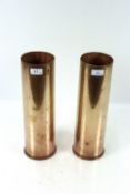 A pair of 105mm M14 shell cases, one with 