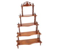 A Victorian walnut graduated what not, raised on spiral turned columns, 73cm wide in extremes x