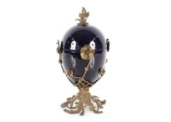 A blue glazed pottery and bronze jar and cover in the Rococo style, decorated flowers heads and